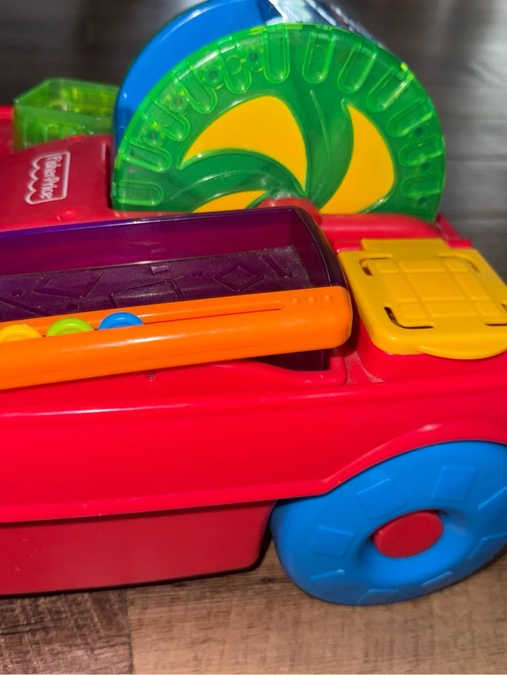 Vintage Fisher-Price Peek-a-boo Pull Toy with Green Handle and Blue Wheels